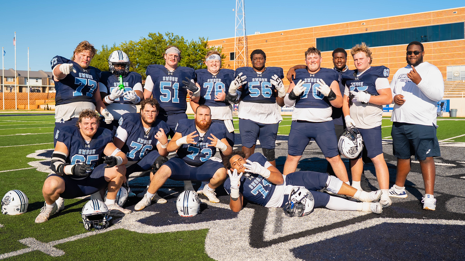 SWOSU Offensive Lineman pose as a group after a win