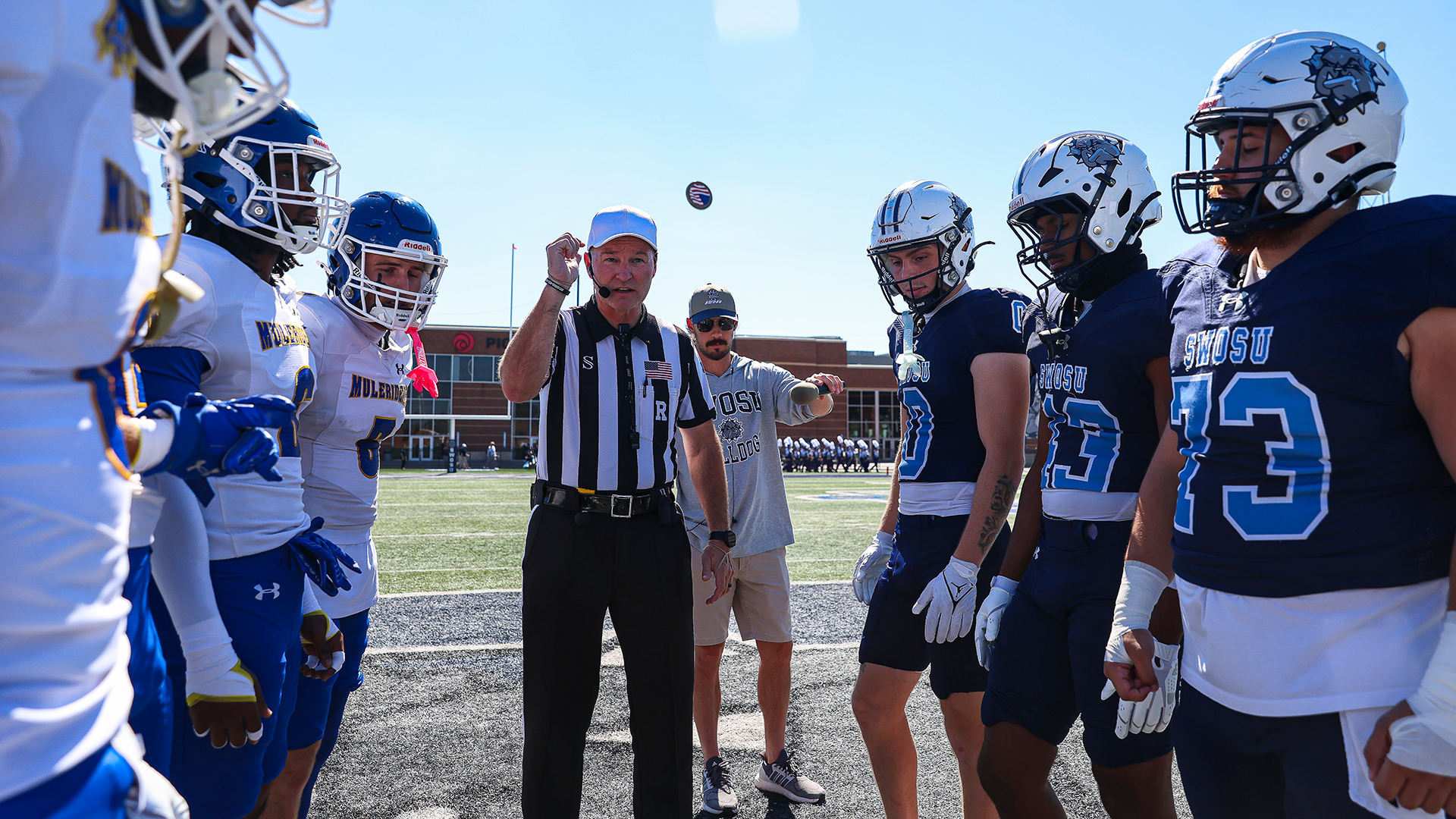 swosu football captains watch the coin flip pregame