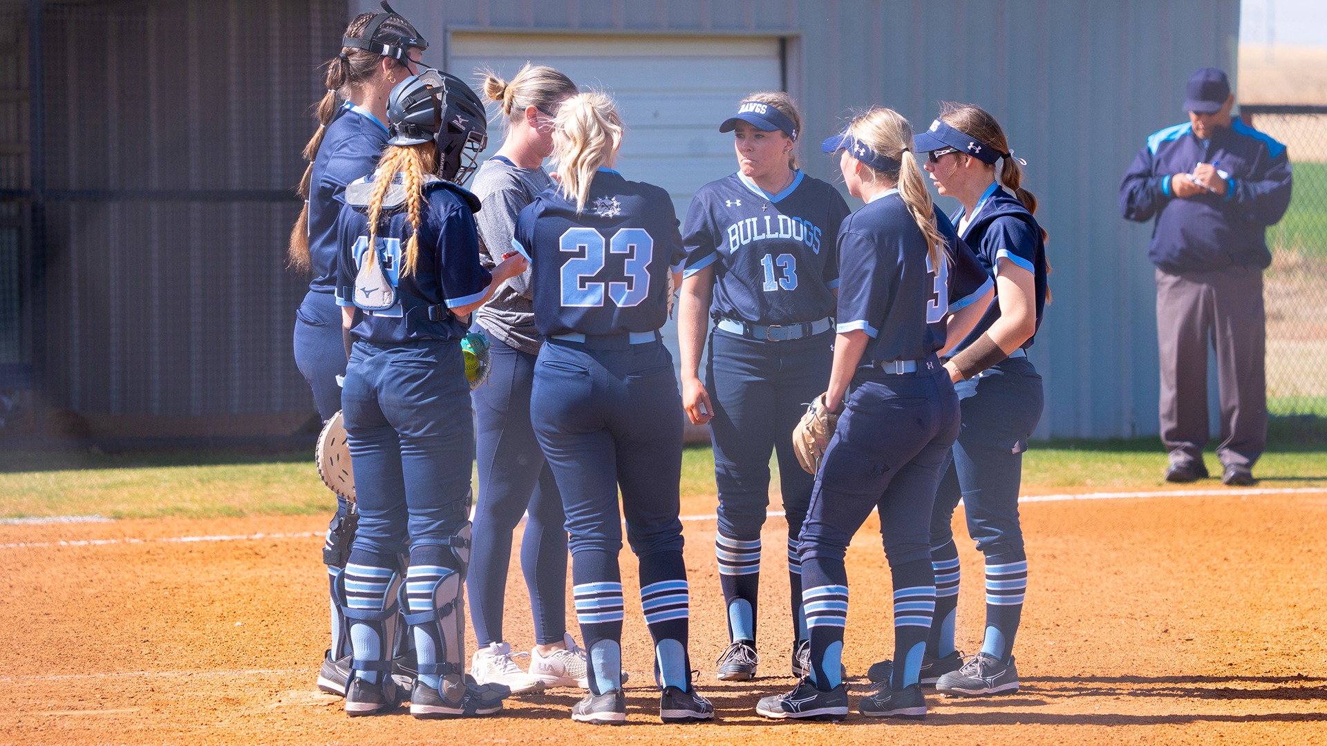 swosu softball infield talks during a circle visit