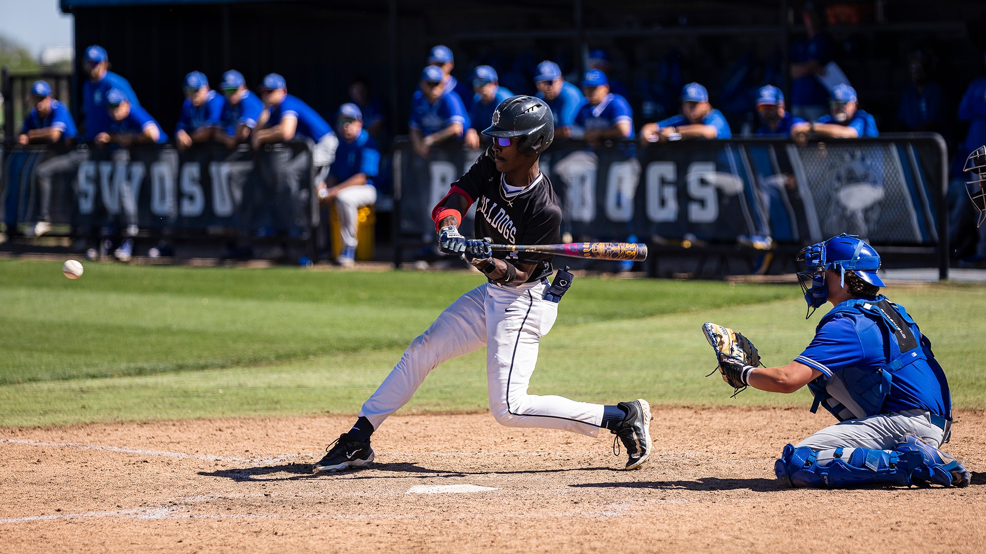 chris clark watches an incoming pitch at the plate