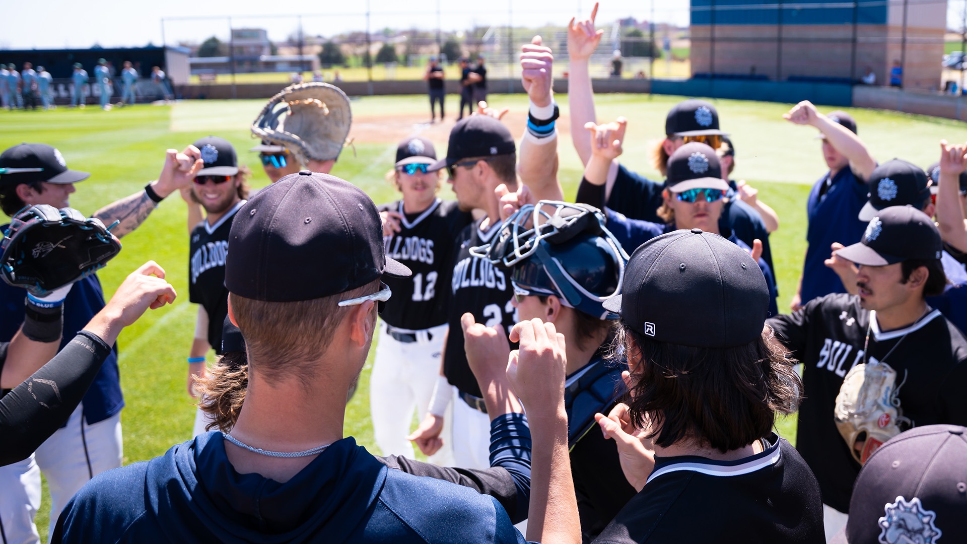 bulldog baseball huddles before running onto the field
