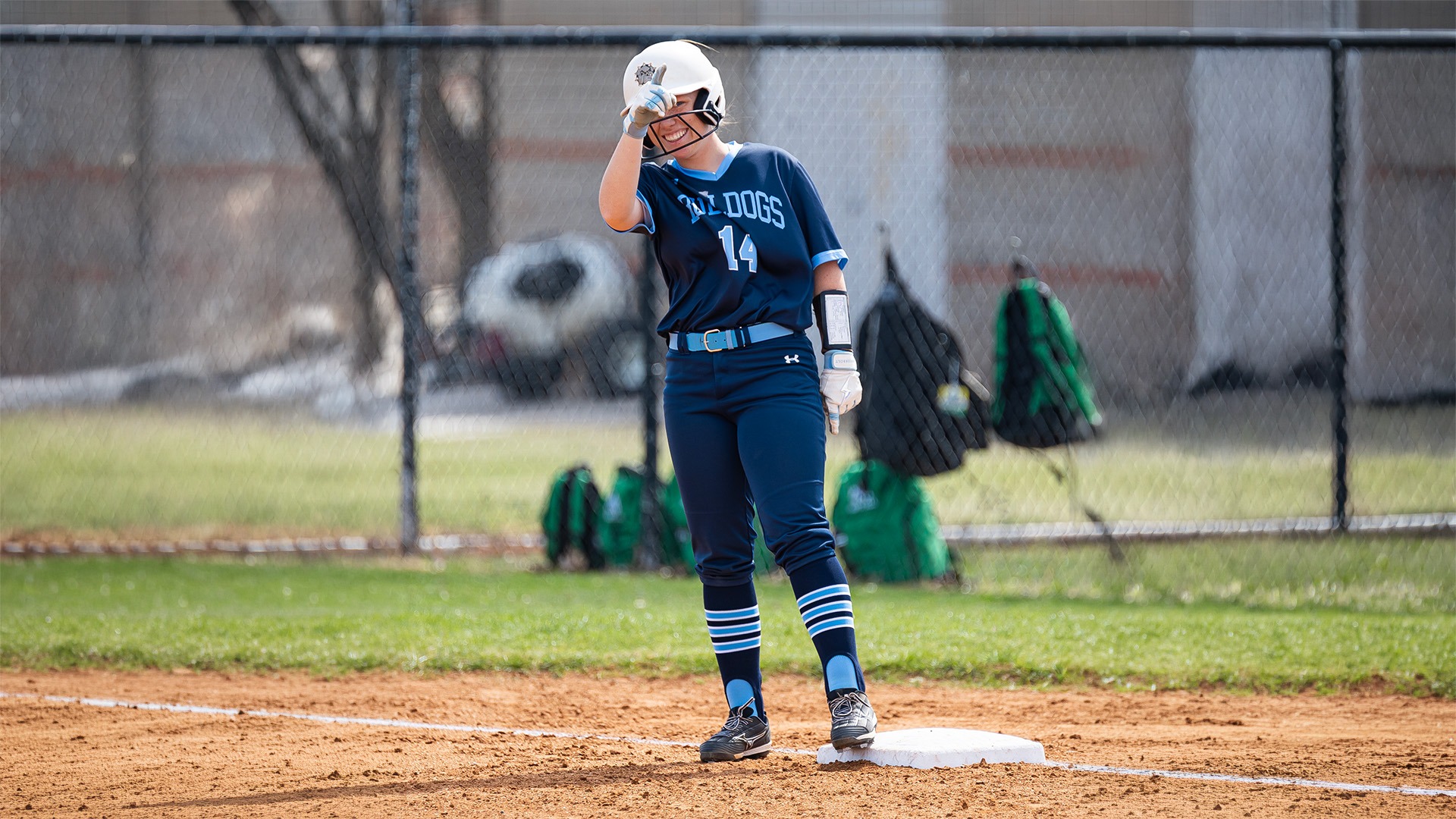 Olivia Brown smiles at first base after reaching safely