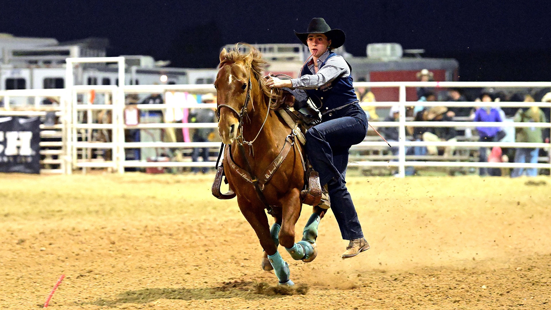 reagan mcintyre disembarks her horse in a goat tying run at fort hays state