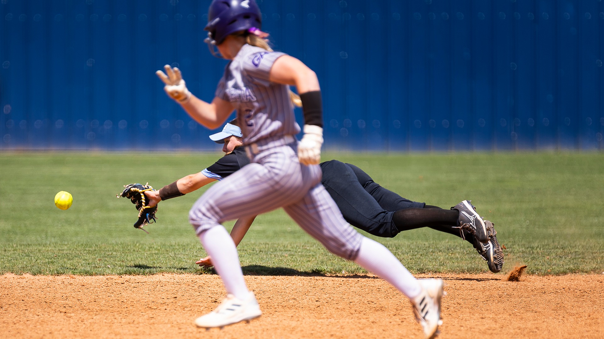 swosu softball infielder dives for a ball against ouachita