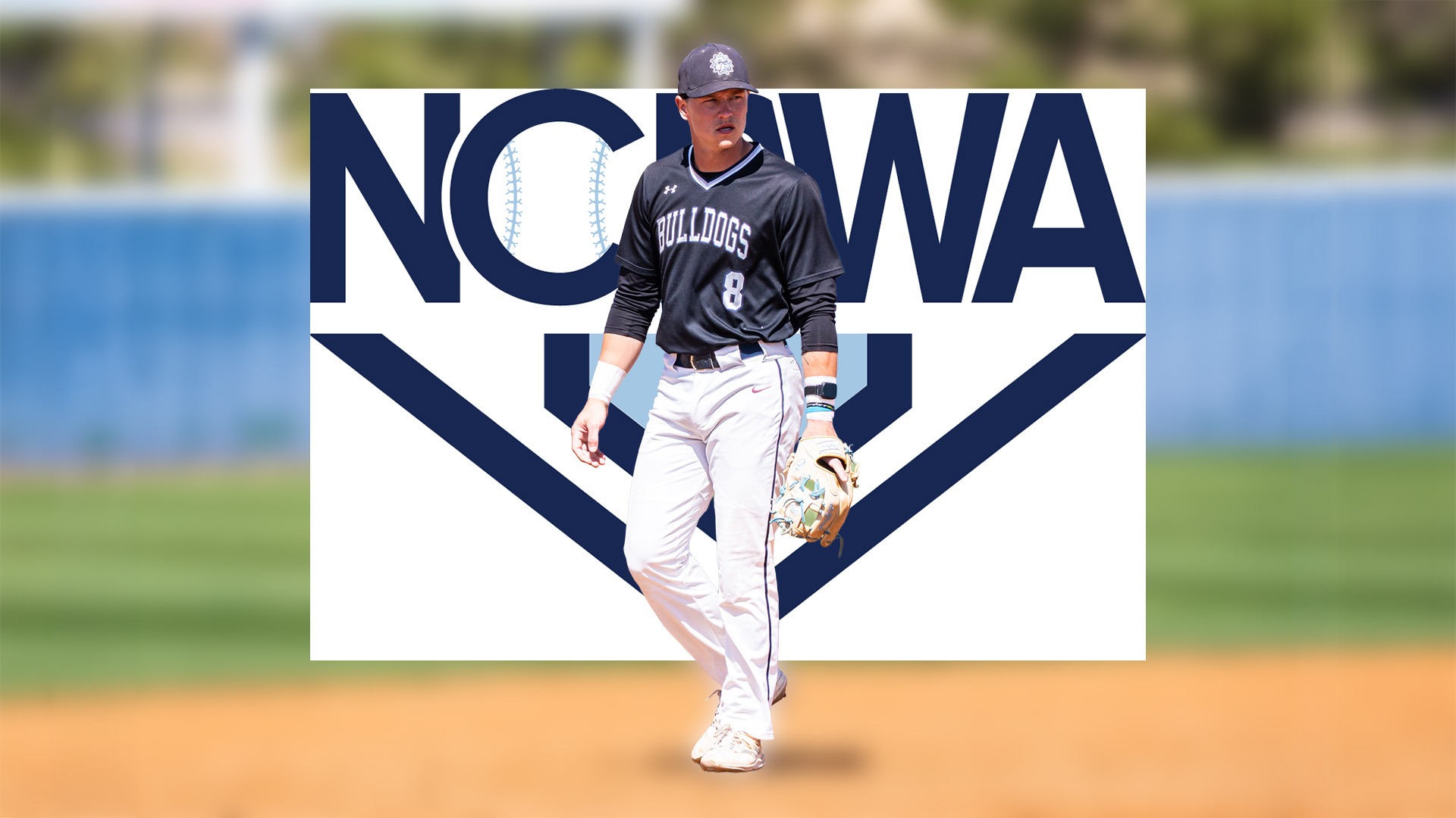 landon meyer stands at third base in front of a NCBWA logo