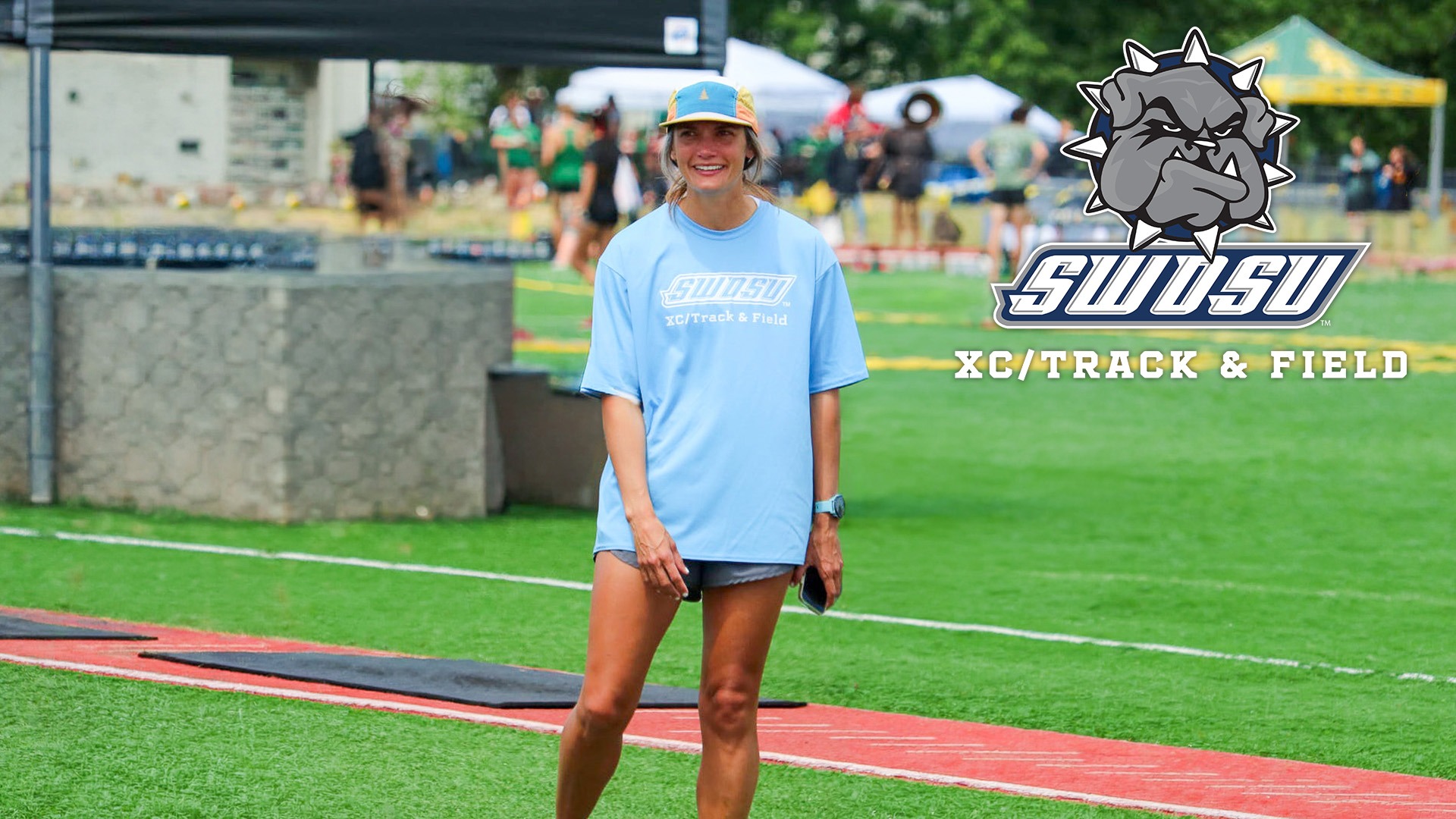coach johnson at a track meet with a swosu XC/Track Logo on the picture