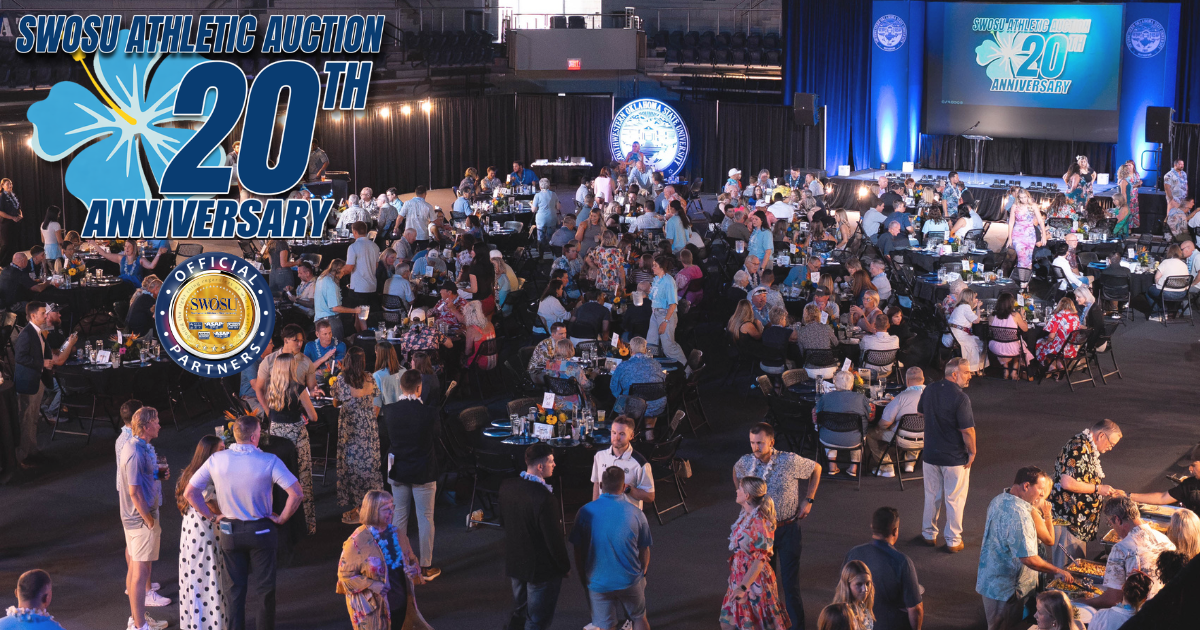 Wide angle shot of the 20th annual SWOSU Athletic Auction showing groups of tables and a crowded Pioneer Event Center
