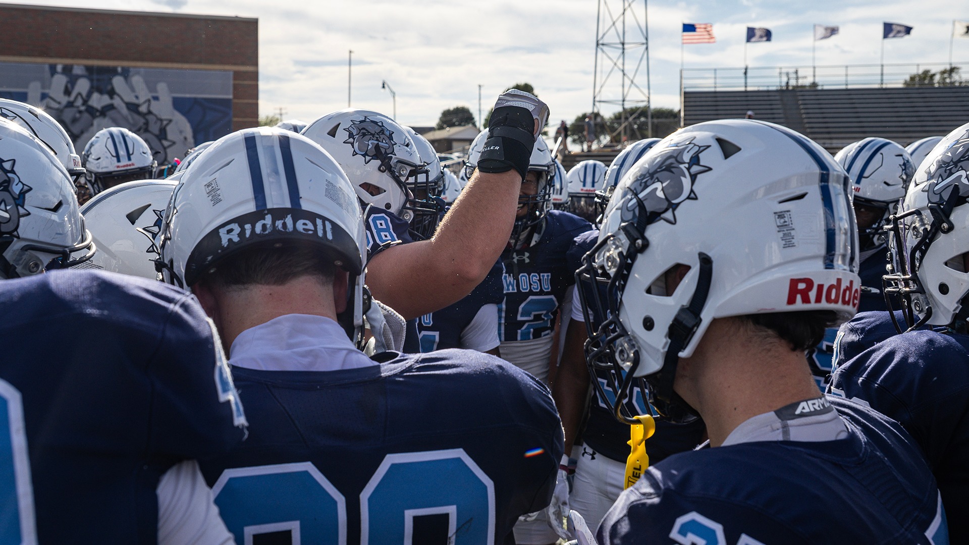 SWOSU Football huddles around a player speaking pregame