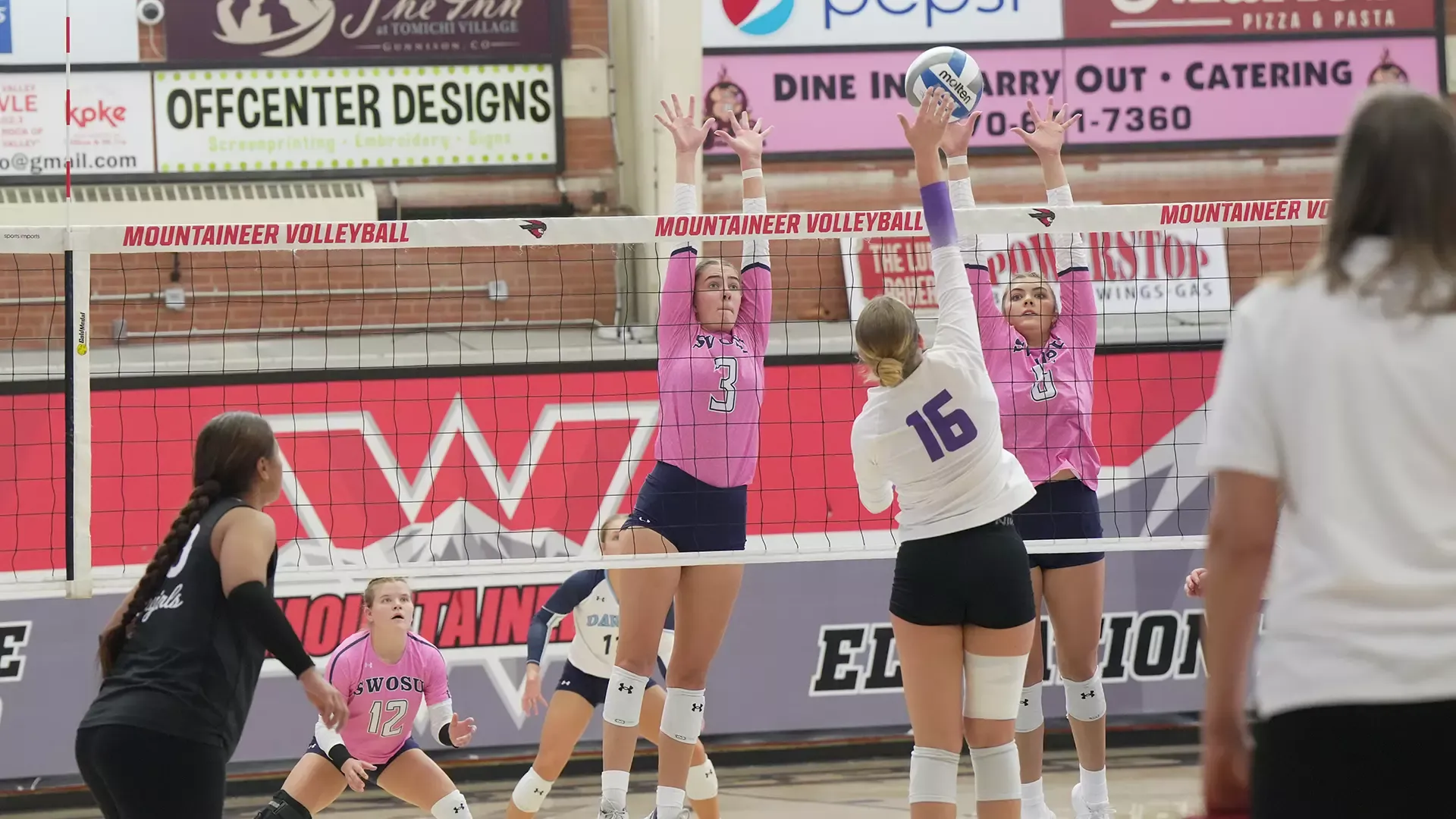 Mackenzie Sims and Sydnee Winfrey go up for a block at the WCU Invitational in Colorado