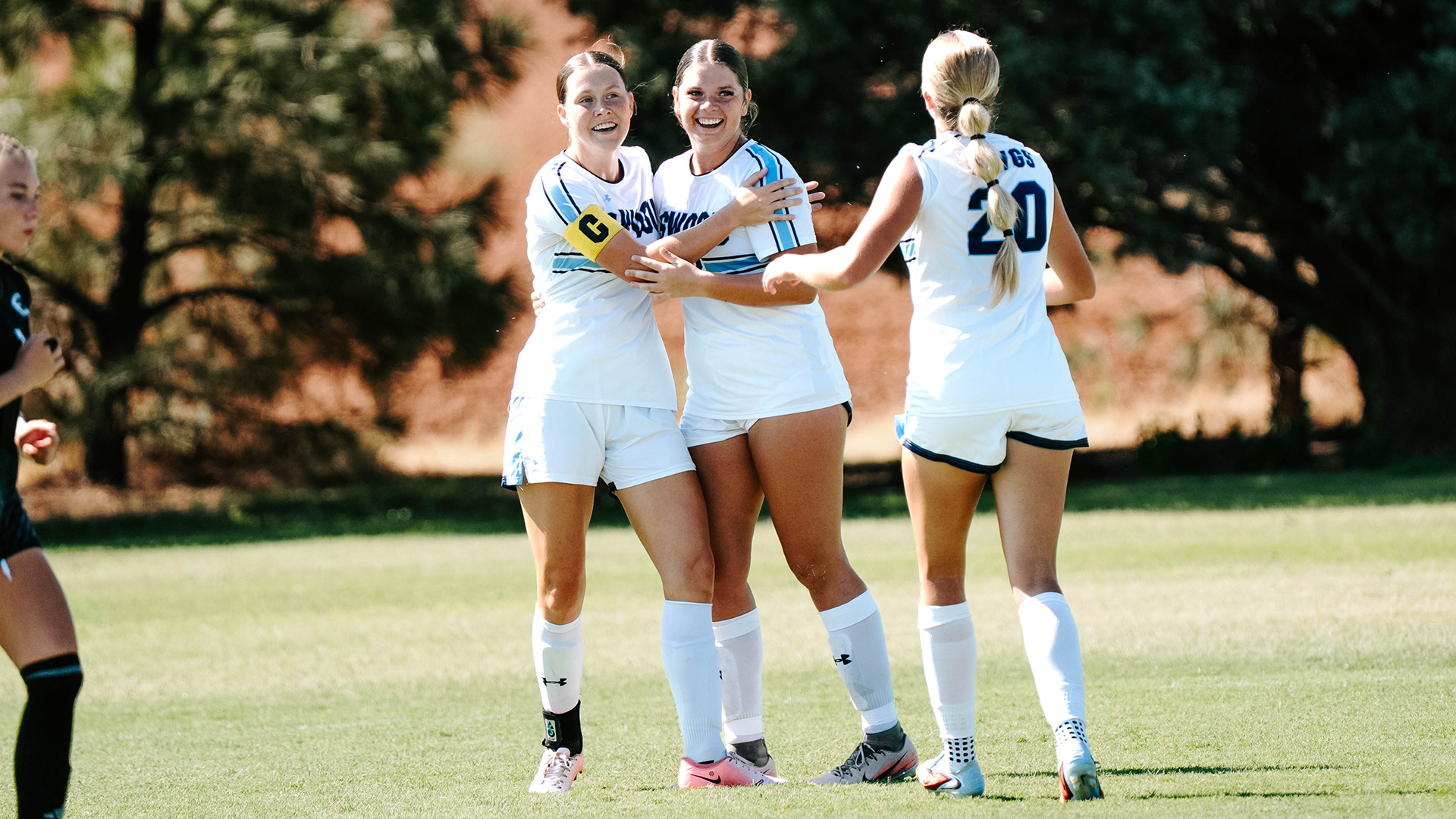 Elise LaForge and Kinsey Geasland hug after a goal
