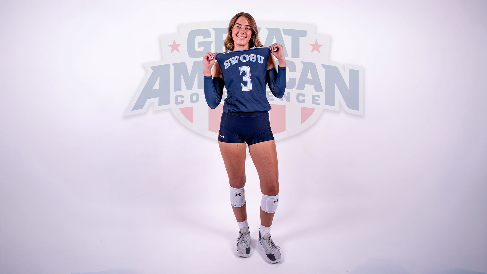Mackenzie Sims poses on a white backdrop in front of a subtle GAC logo inserted into the picture