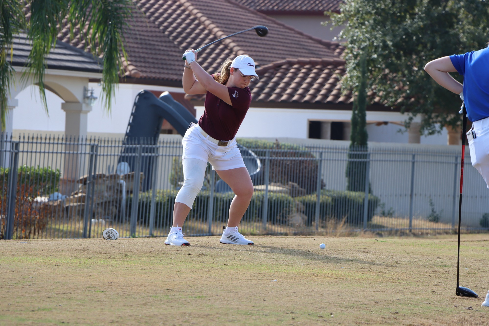 TAMIU golfer teeing off a shot during a tournament