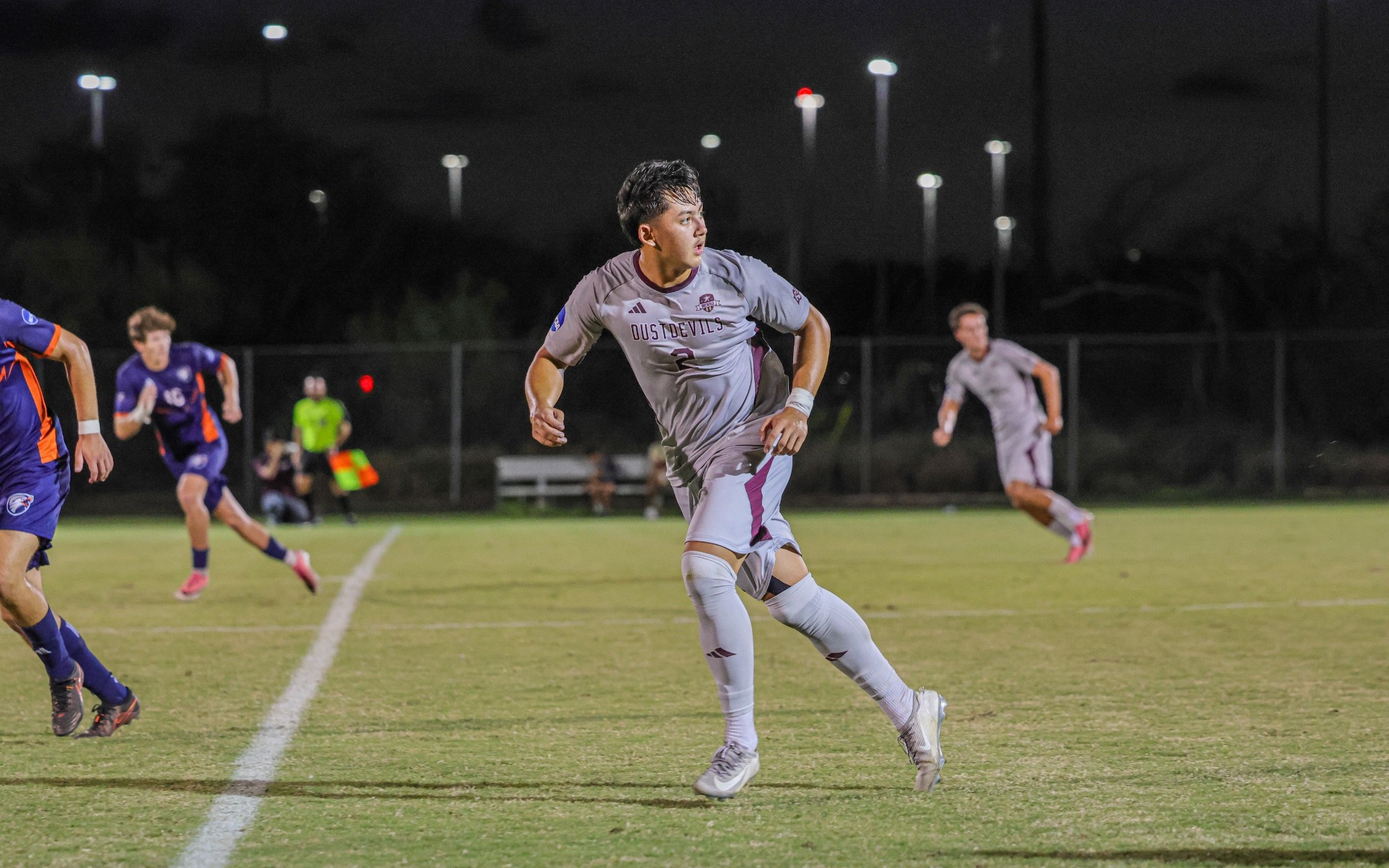 Aidan Williams running while looking over his shoulder.