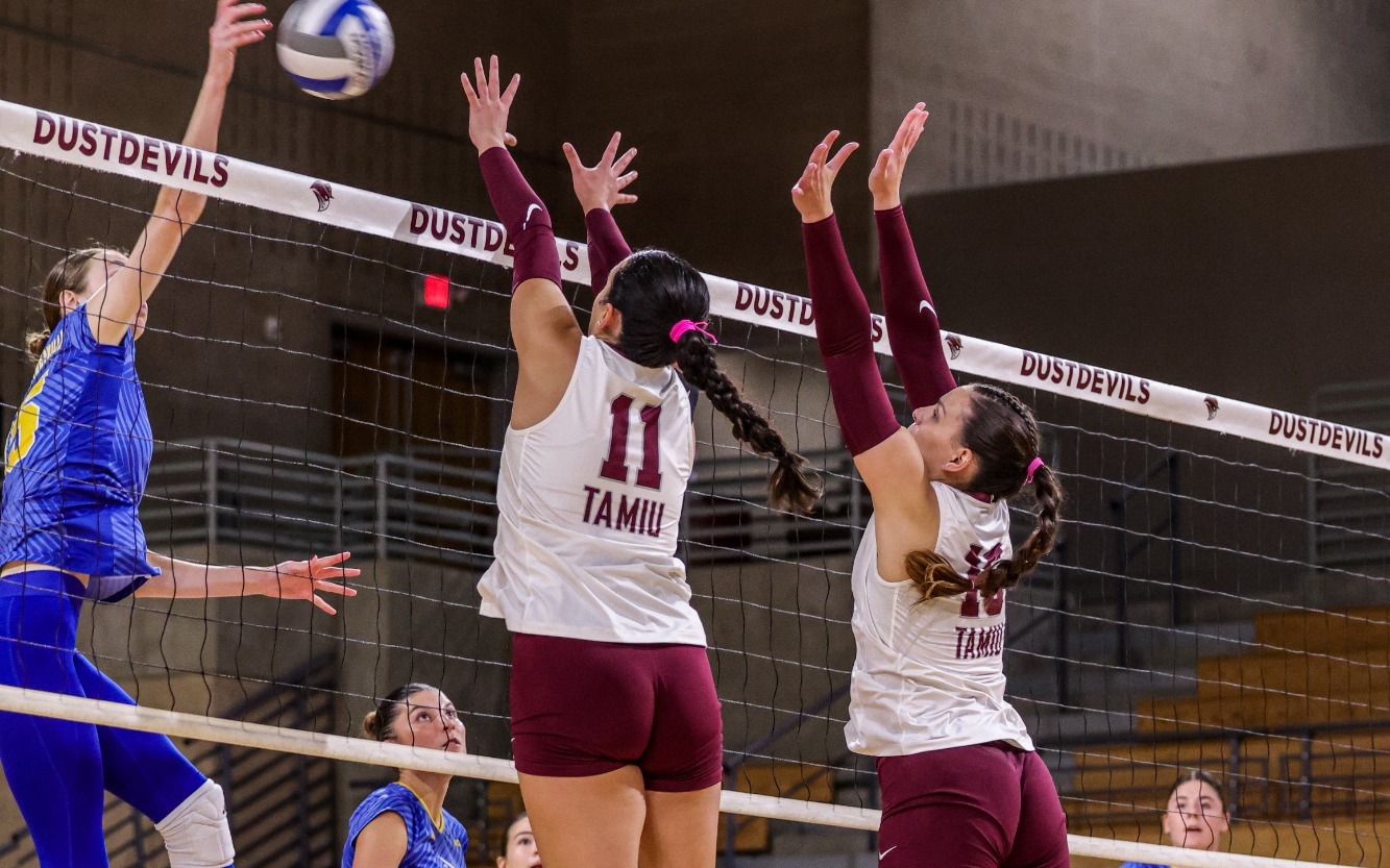 Mia Molina and Fernanda Izar up at the net for a block.