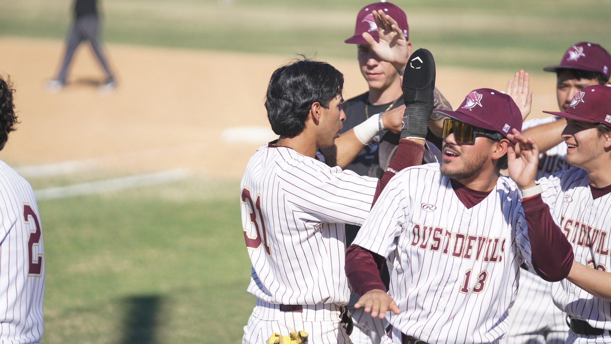 Ciro Benavides is Greeted By His Team After Scoring a Run