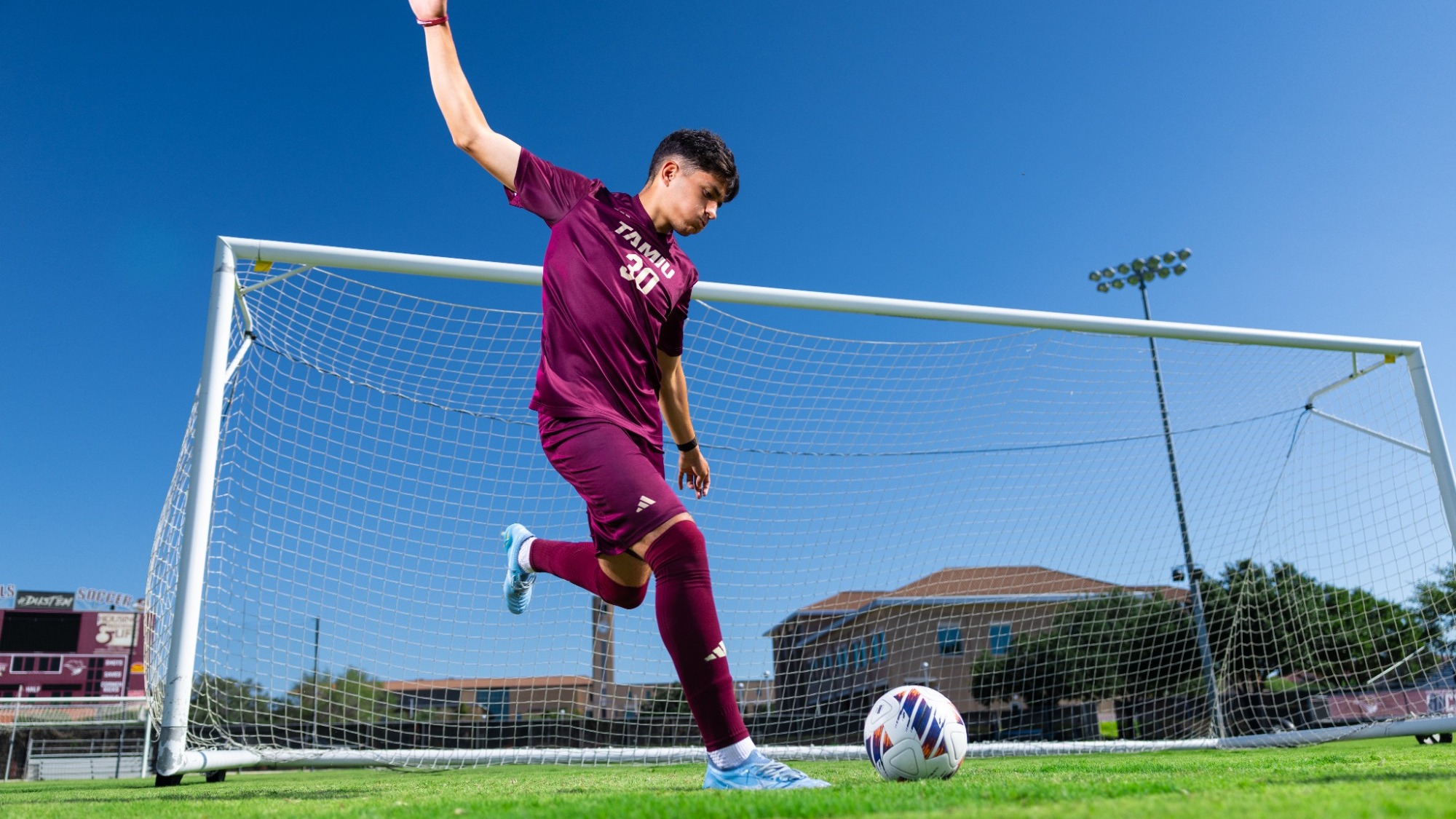 Kamal Zulfiyev kicks the ball on Media Day