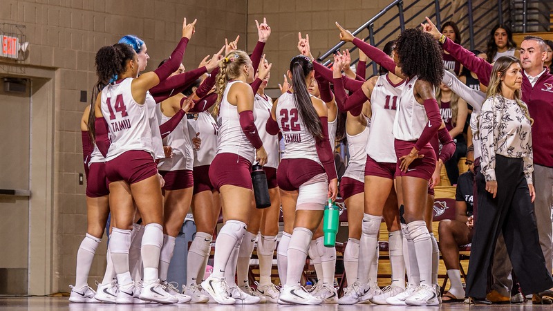 Dustdevil Volleyball huddles during a match with DBU