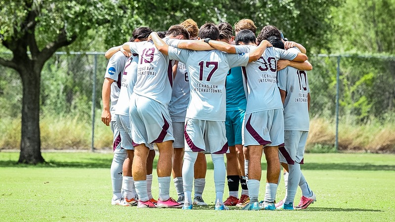 TAMIU Men's Soccer huddle together