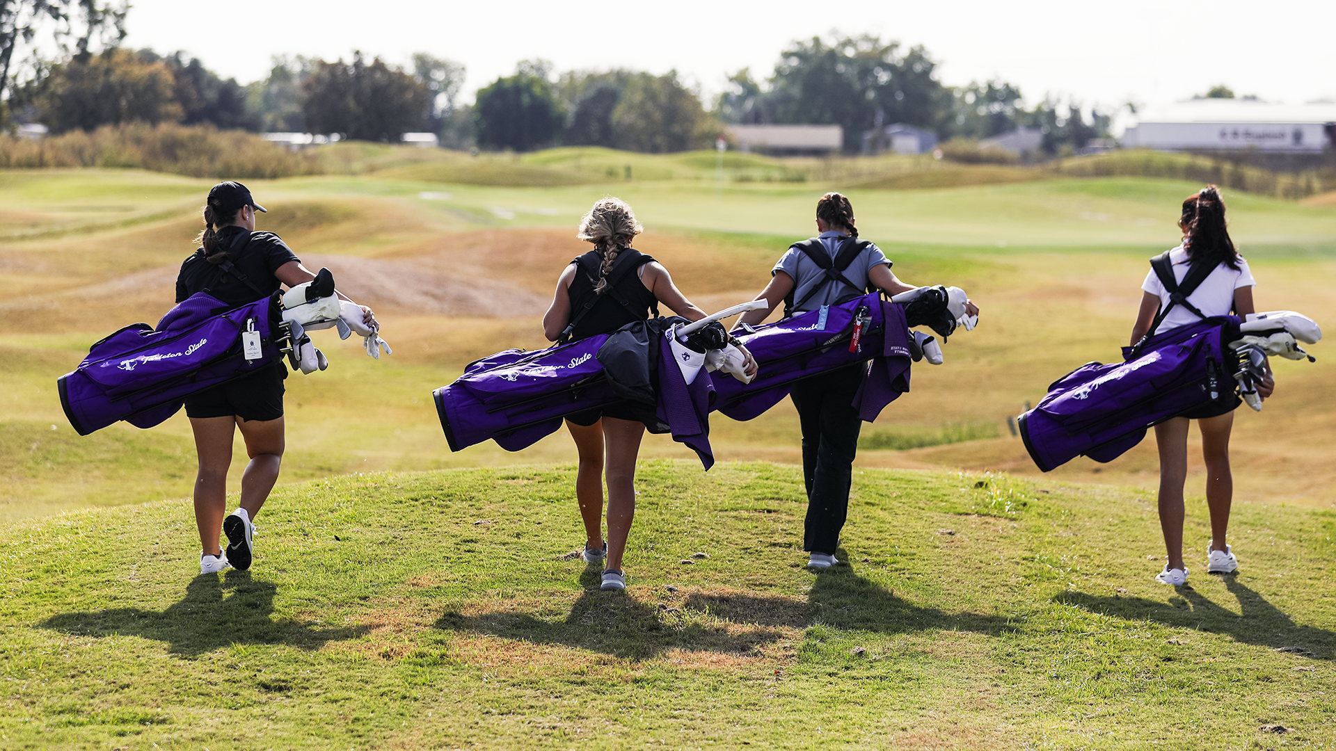Tarleton State Women's Golfers walking to next hole with golf bags. (Photo used Oct. 26)