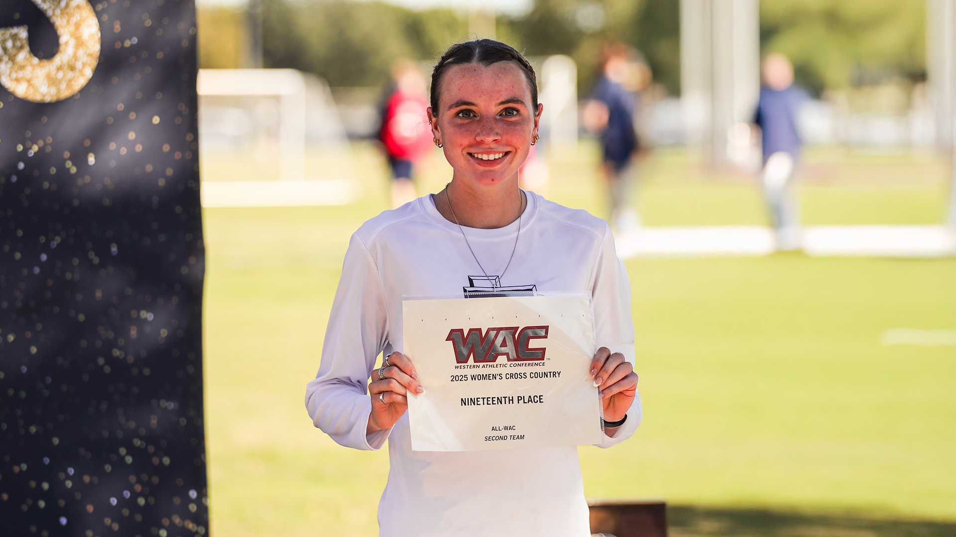 Kaitlyn Gale holds WAC Championship 19th place certificate (Photo used Oct. 31st)