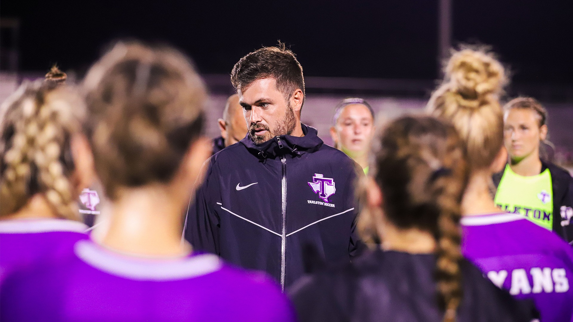 Coach Rex Carrell talking to the soccer team.