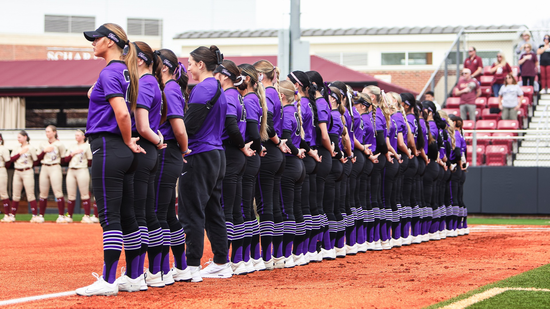 Texan Softball during the national anthem in their second game against Elon at the UNCG Tournament in North Carolina.