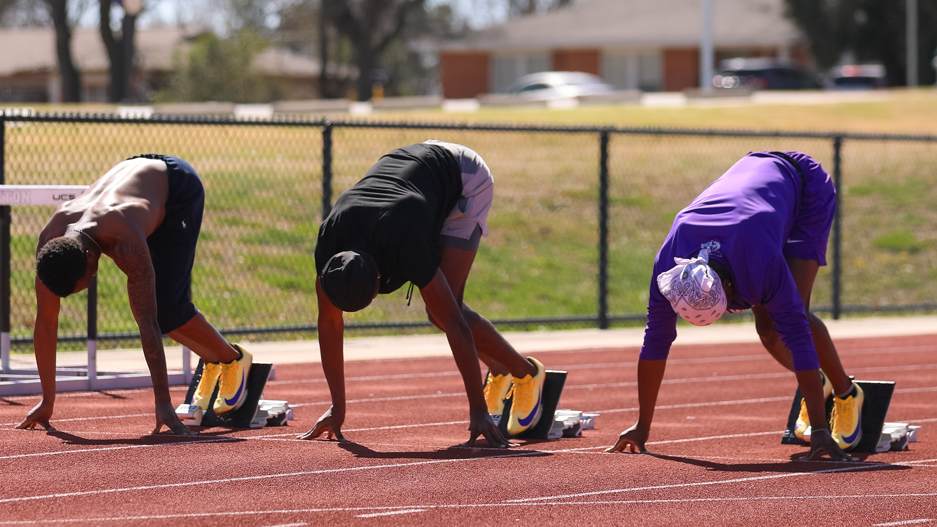 Tarleton State track and field sprinters in blocks