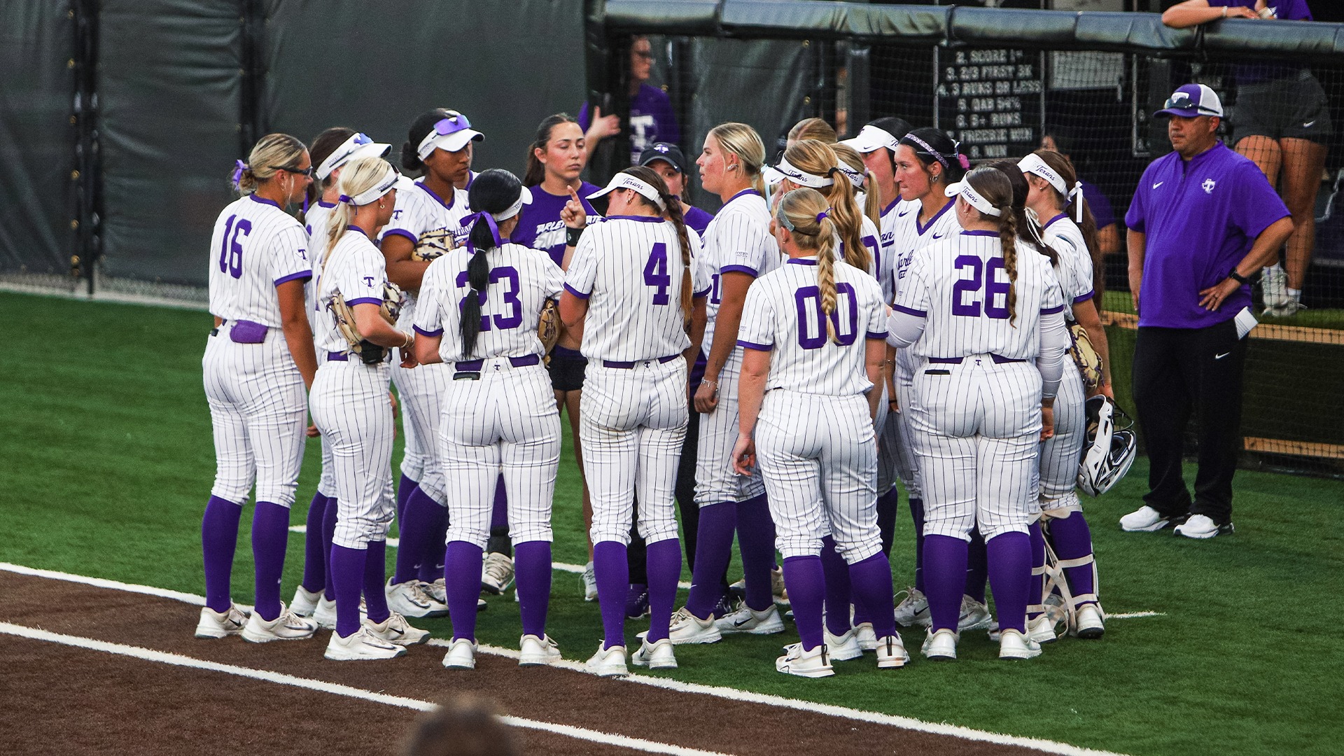 Texan Softball huddle during day one of Rhode Island series.