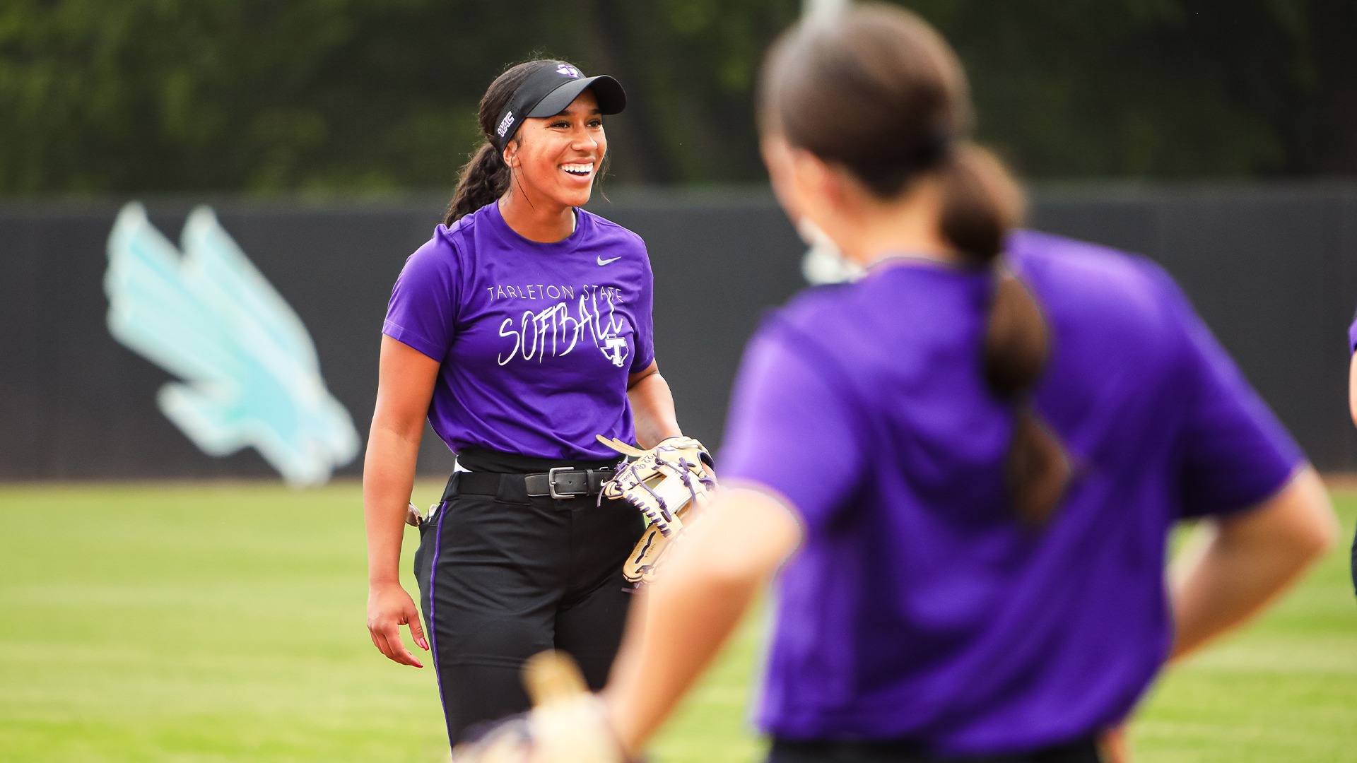Izzy Bojkovic warming up before Texan Softball's game at North Texas.