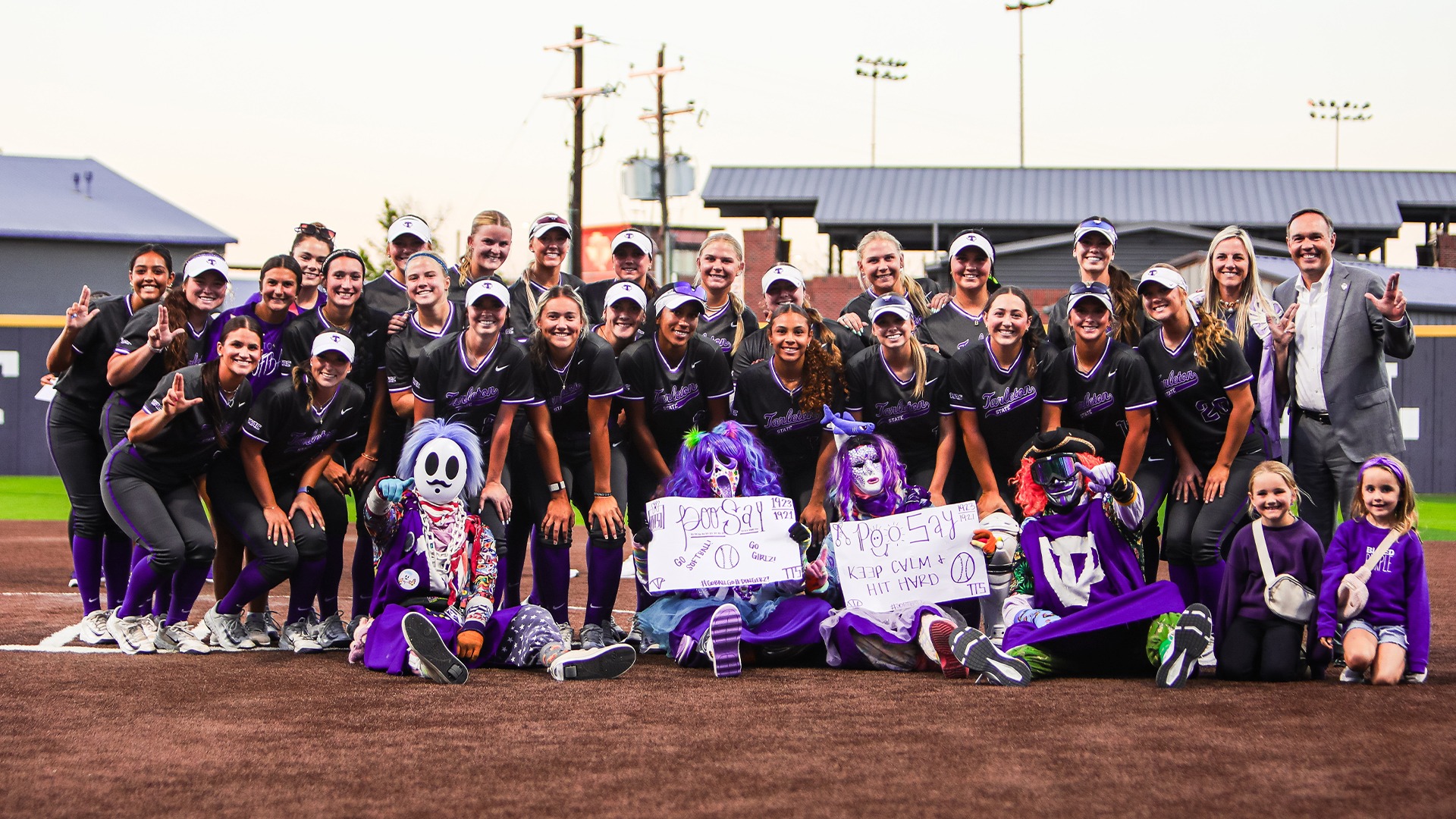 Dr. Hurley and the Purple Poo with the Texan Softball team after their game against UNT.