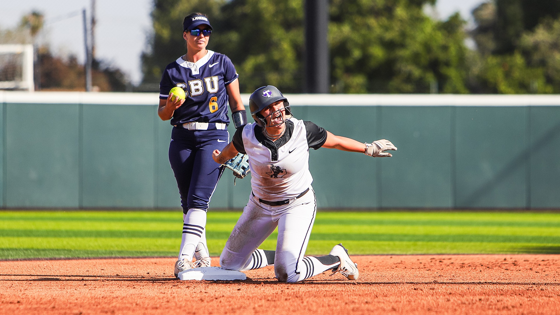 Casey Schultz celebrating after hitting a double against CBU.