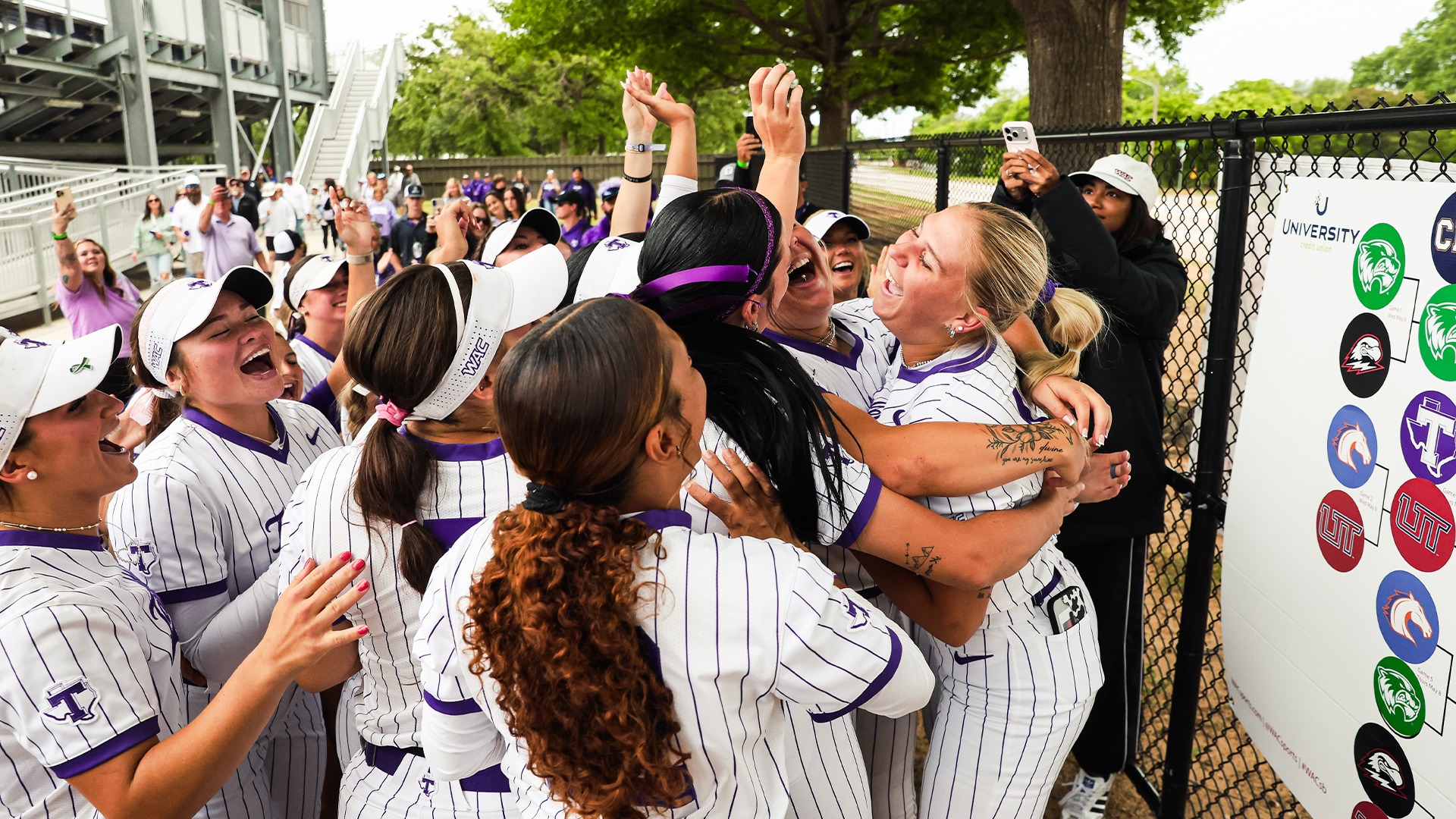 Texan Softball celebrating after their quarterfinal win over Utah Tech.