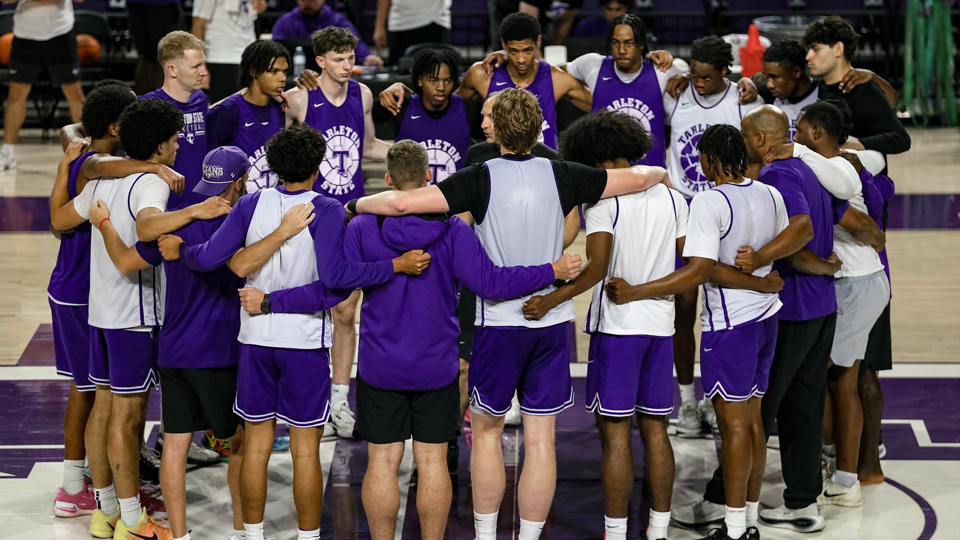 Men's basketball team huddle at practice at the EECU Center