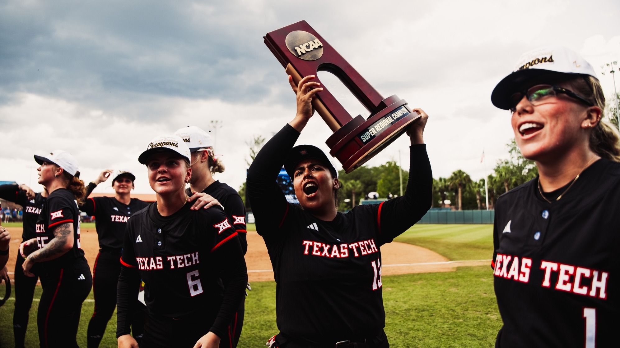 Texas Tech's Victoria Valdez hoists the Gainesville Super Regional trophy after the Red Raiders' 16-7 Game 3 win over Florida