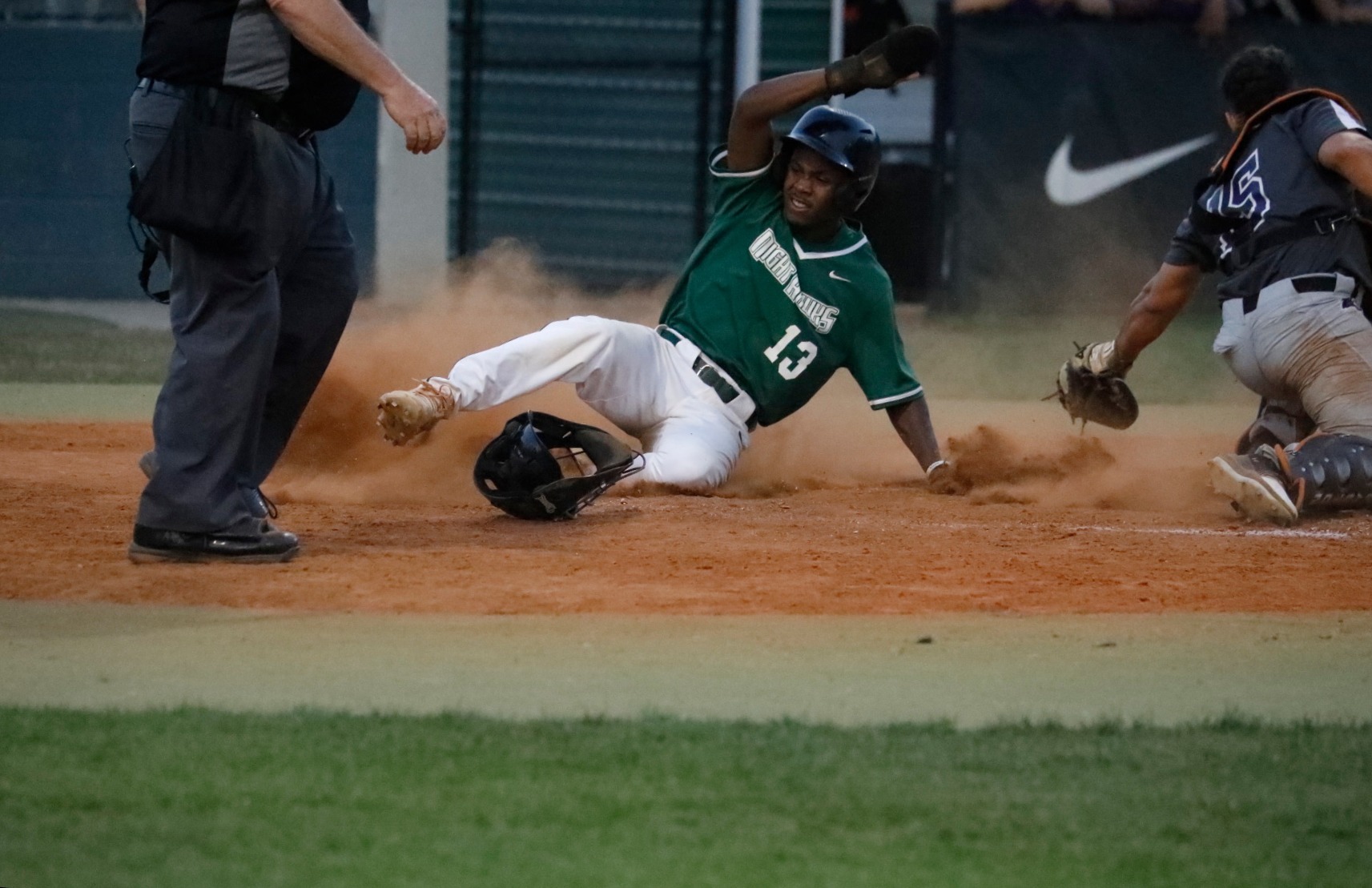 TJ Jones Jr slides into home plate