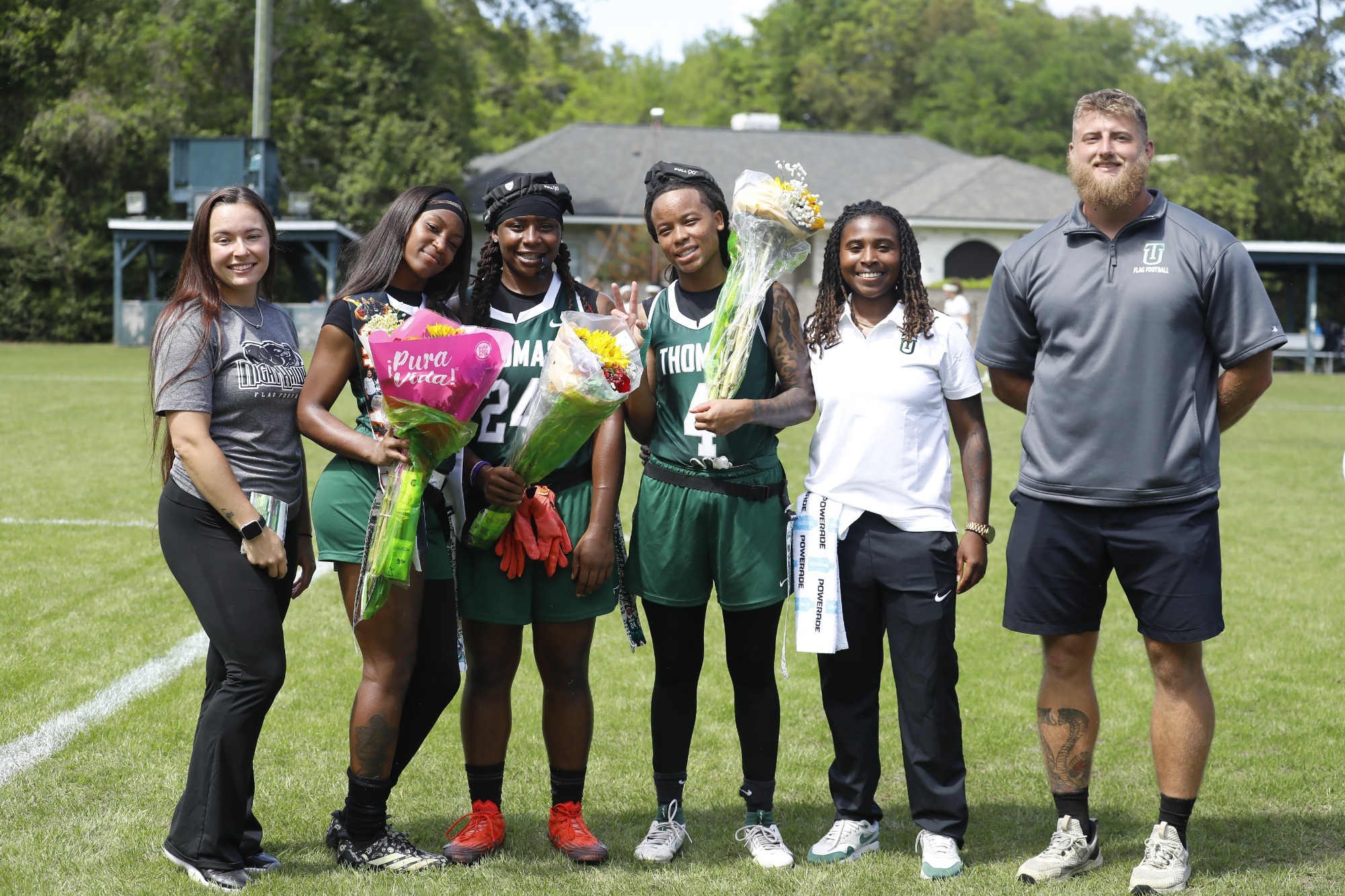 Holly Neher, Dyva Jones, Ameari Logan, Destiny Lockett, Ni'Ja Seals, Matt Bowman stand for senior day photos. 