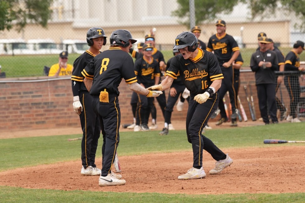 Caleb Small celebrates after inside the park homer
