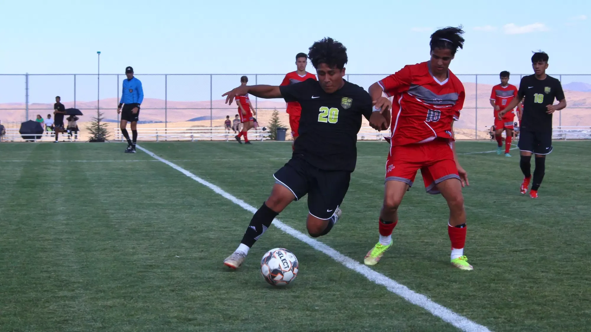 men's soccer player Ryan Soto fights for possession of ball
