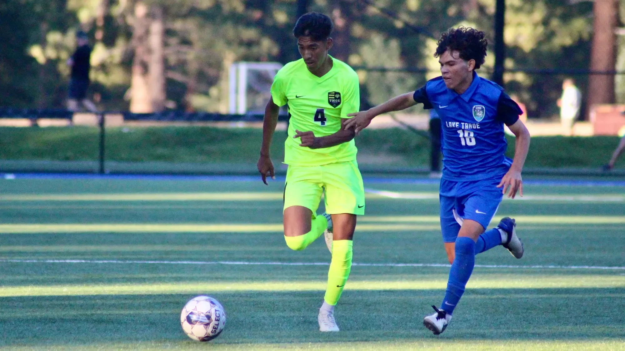 men's soccer player Edil, jersey 4 fights for possession of ball @ LTCC