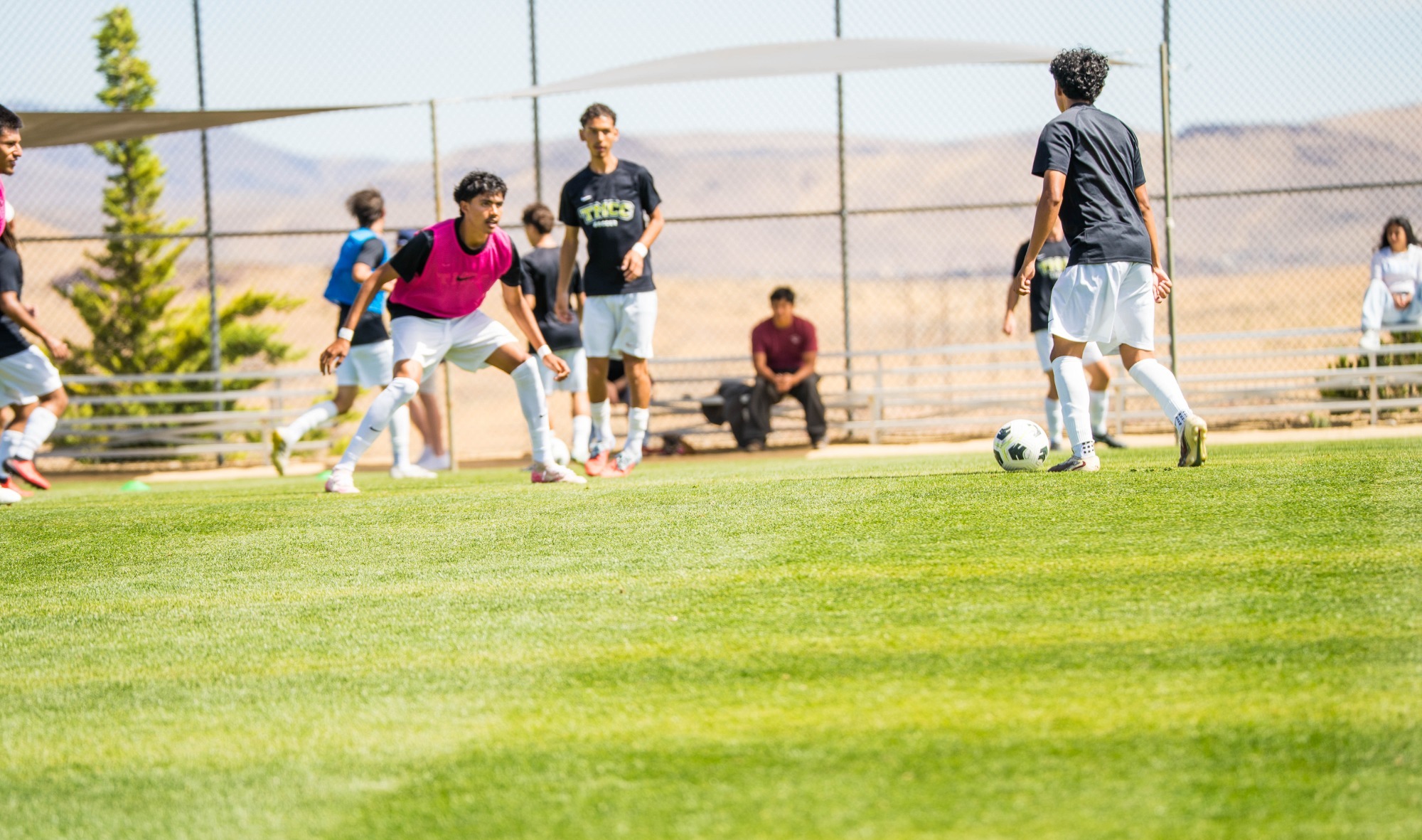 Men's soccer players warming up before the game playing a rondo. 