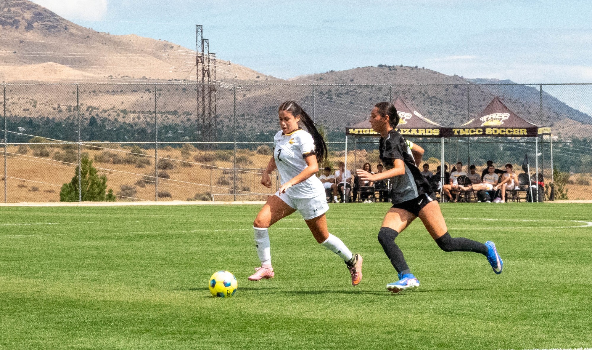 Women's Soccer player, Isis Melendez, chasing CSI opponent number 2 to gain possession