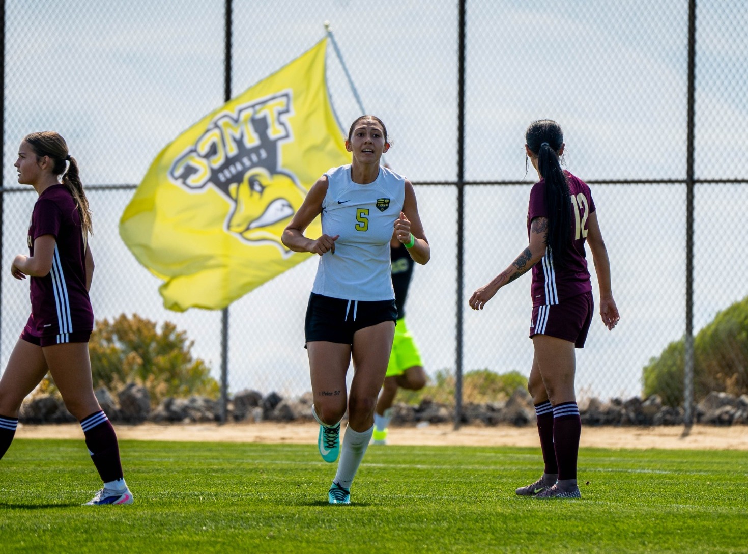 Chloe McMinn with TMCC flag in background
