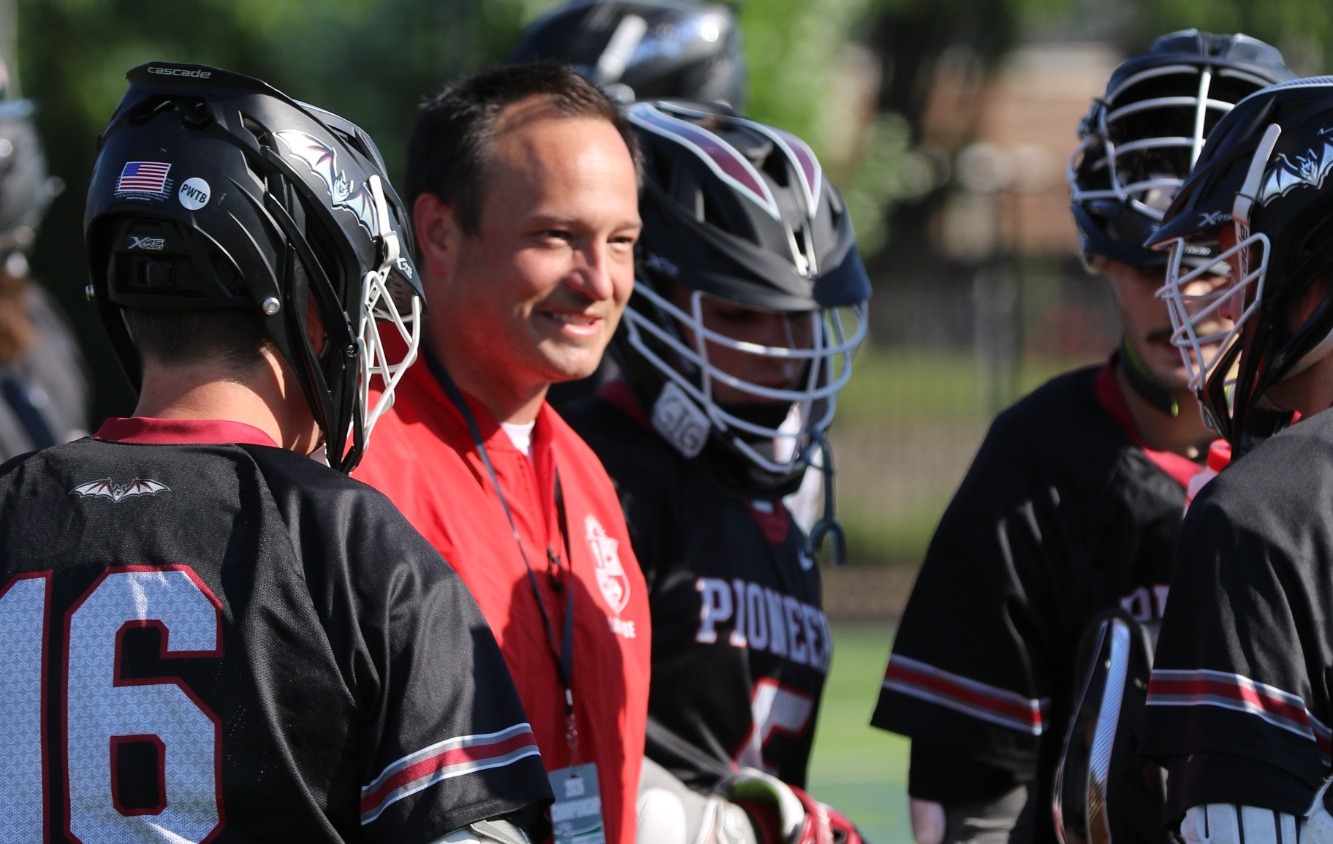 Head Coach Logan Otto talks with members of the team during a timeout at the HCLC Tournament. 