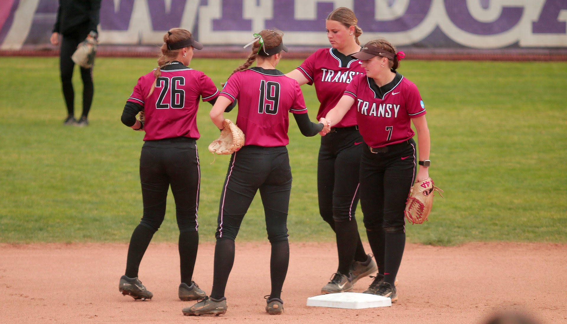 Transylvania's softball team huddled at second base during Region play at Linfield in McMinnville, Oregon. 