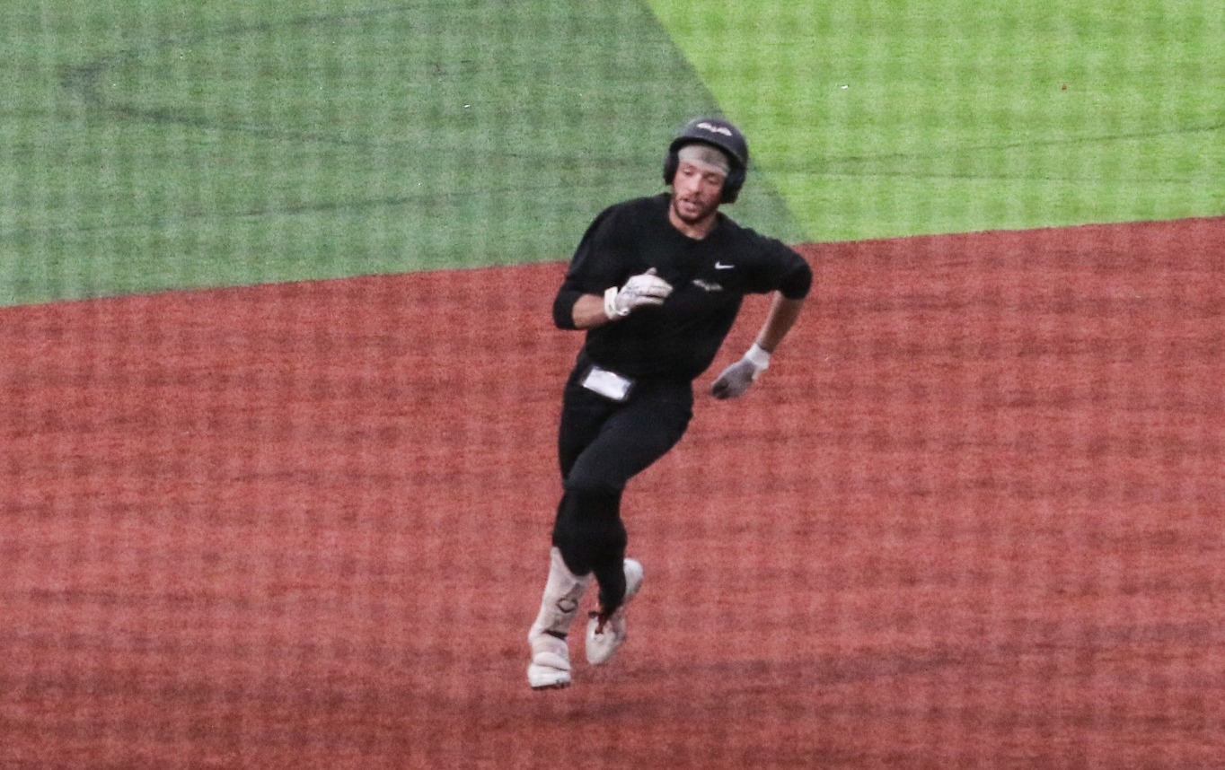 Ethan Dillon (#21) scores on an inside the park home run. 