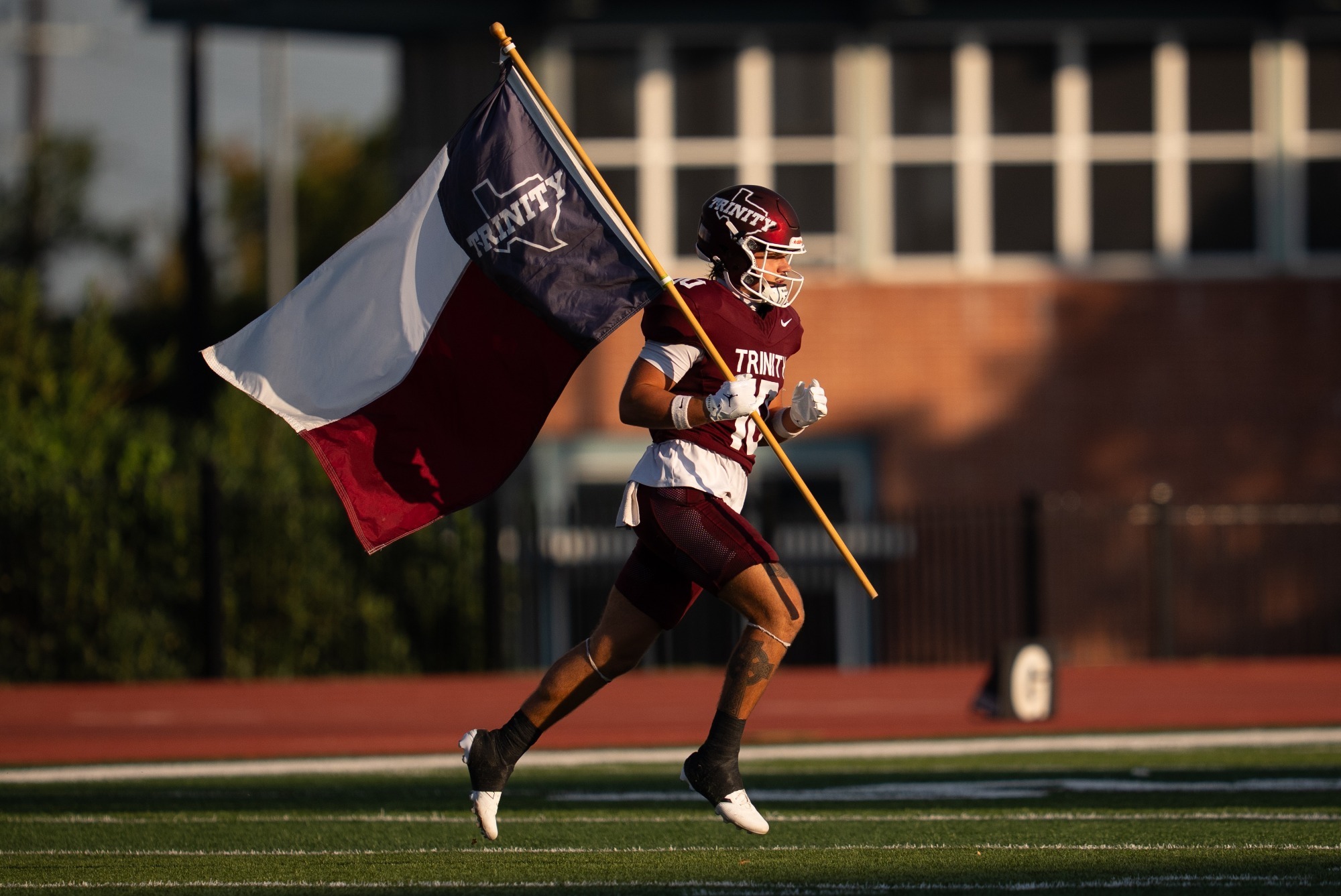 fb player running out of tunnel with flag