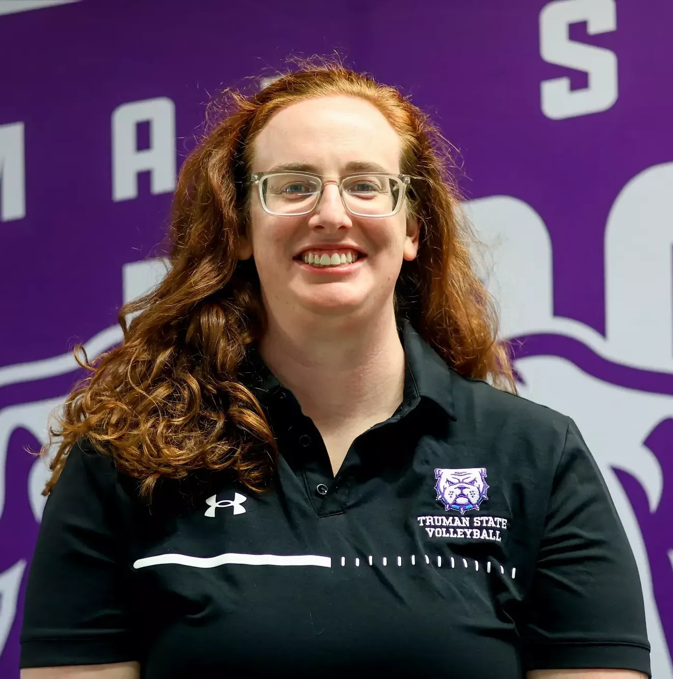 Jacquie Cason Staff Headshot in front of purple backdrop