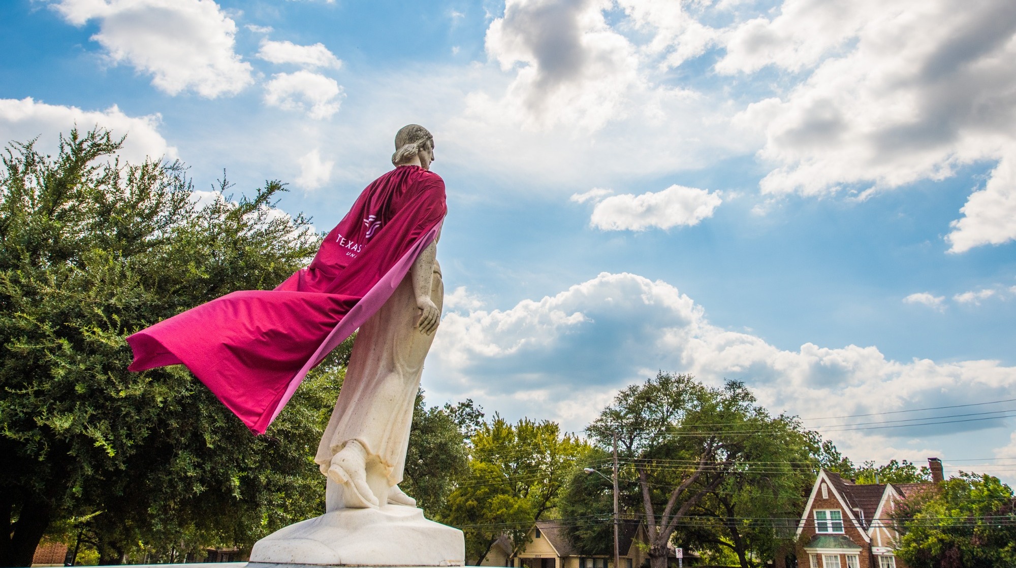 The Pioneer Woman statue at Texas Woman's University with a cap on. 