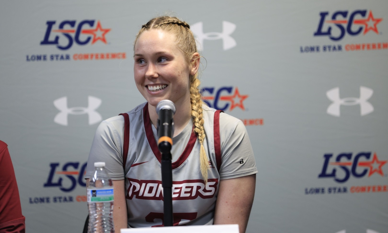 Gabby Elliott sitting in LSC Postgame Press Conference in front of microphone.