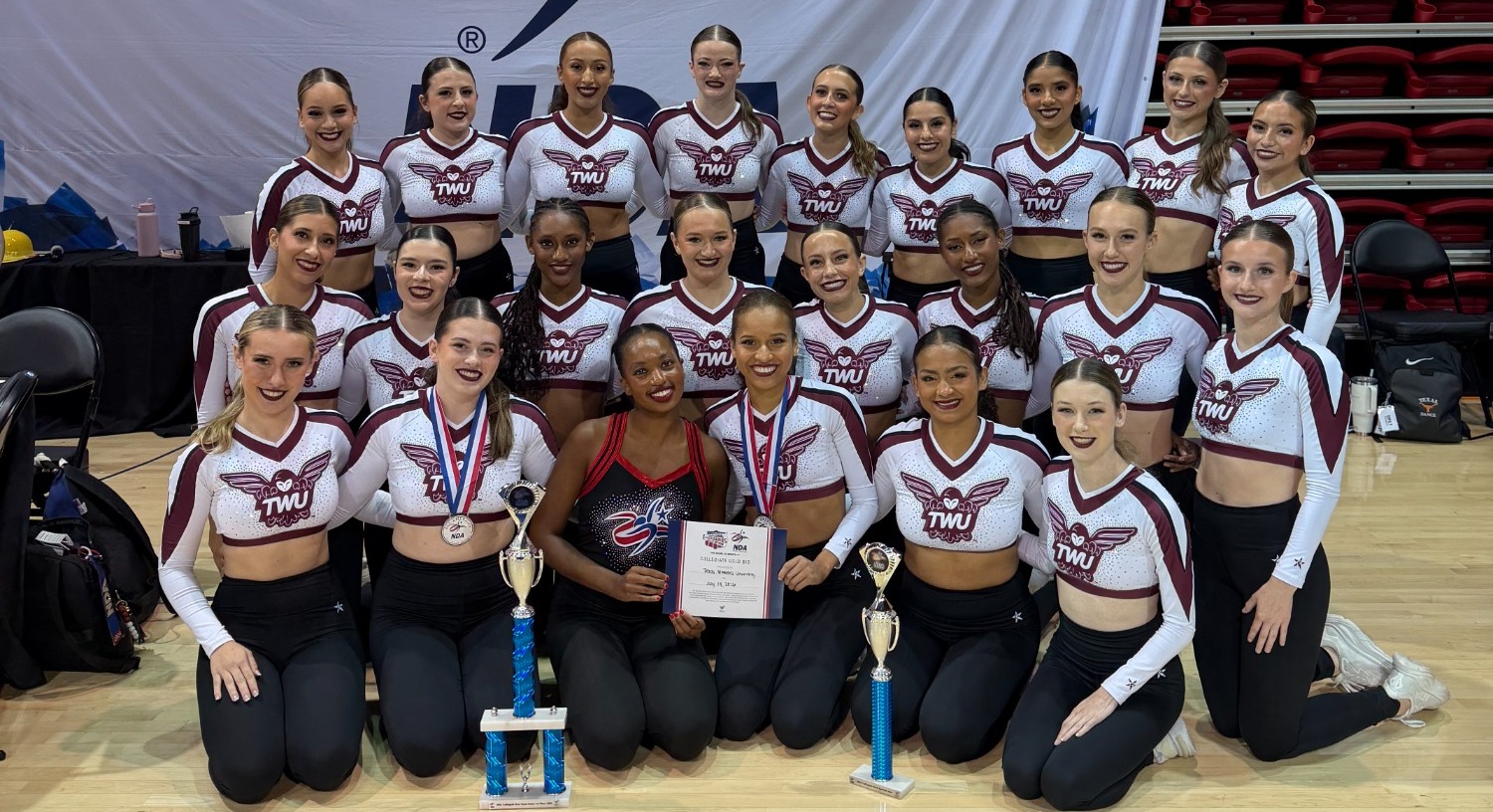 Pioneer Pride Dance Team poses with trophies from 2026 NDA Summer Camp